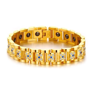 Macro detail of stainless steel mark and inlaid blue stones on gold magnetic bracelet