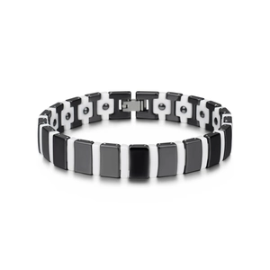 Detail of black and white ceramic magnetic bracelet with polished metal folding clasp