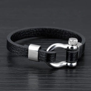 Minimalist black leather bracelet with a polished silver stainless steel shackle clasp