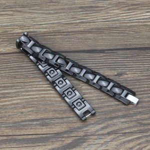 Polished black ceramic magnetic link bracelet for men with folding clasp on wooden background