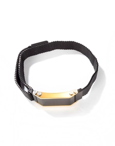Detail of men's black mesh steel bracelet with black and gold plate and silver rivets