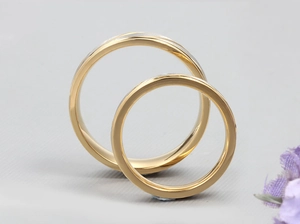 Detail of two-tone gold and silver titanium steel rings with matte and polished texture
