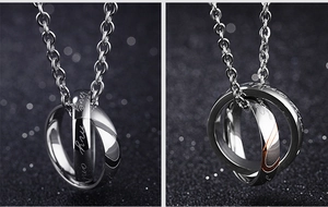 Detailed macro view of interlocking silver rings pendant with Love my only engraving