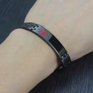Close-up of black titanium medical alert bracelet with red Star of Life on male wrist