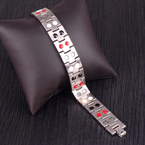 Macro detail of men's titanium magnetic bracelet with multi-color energy stones on display