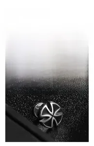 Macro view of silver stainless steel stud earring with four-petal cross texture design