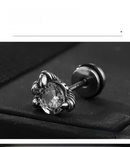 Macro shot of crown-set zircon stud earring with industrial matte finish and barbell back