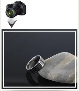 Detailed macro shot of vintage industrial steel ring with vine texture on grey stone