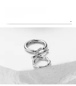Polished stainless steel OT toggle clasp with bamboo texture on a minimalist stone base