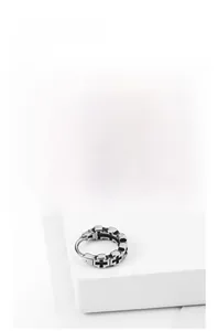 Close-up of retro stainless steel hoop earrings featuring engraved black gothic crosses