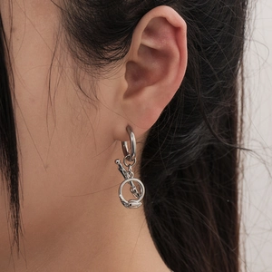 Minimalist silver tulip drop earrings in stainless steel on a female model