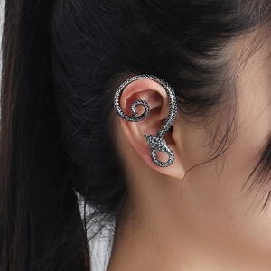 Vintage silver snake ear cuff with textured scales shown on model ear