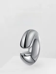Close-up of a silver-toned polished stainless steel hoop earring with a sleek mirror finish