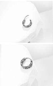 Detailed macro view showing the textured vintage titanium steel hoop earring open and closed