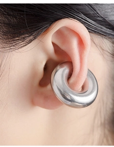 Macro shot of silver stainless steel ear weights with a thick circular minimalist design