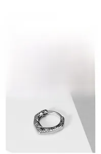 Close-up of vintage silver huggie earring with radial sunburst engraving and aged finish
