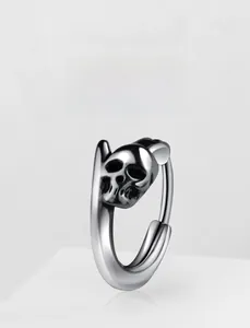 Detailed view of punk style skull earring made of vintage finish stainless steel