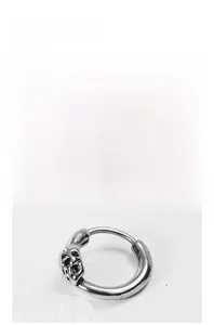 Close-up of vintage silver skull hoop earring in titanium steel with punk style detail