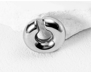 Close-up of a silver polished C-shaped wolf fang earring made of premium stainless steel