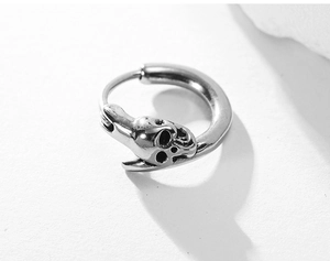 Close-up of gothic skull earring in vintage stainless steel with detailed engraving