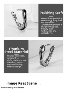 Macro detail of twisted titanium steel hoop earring with mirror polished surface