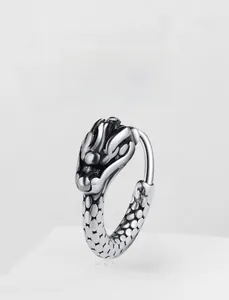 Detailed view of vintage silver dragon head hoop earring with intricate scale textures