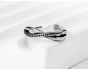 Macro shot of vintage titanium steel earring with infinity design and beaded texture