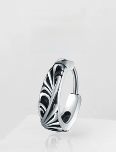 Detailed view of silver stainless steel earring with vintage relief patterns and dark oxidation