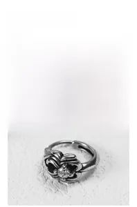 Macro view of vintage style ring with intricate floral engraving and central zircon stone
