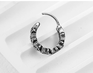 Macro view of vintage silver steel hinged clicker with embossed star and stripe detail