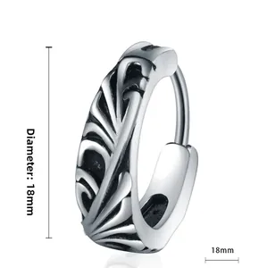 Close-up of 18mm vintage titanium steel hoop earring with detailed feather engravings