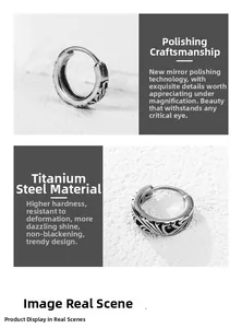 Detailed macro view of retro silver titanium steel earrings with gothic cross engraving