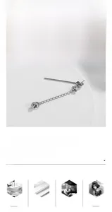 Detail of silver chain earring with round ball pendant in polished titanium steel
