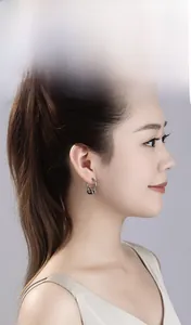 Side view of model wearing minimalist silver double-ring stainless steel hoop earrings