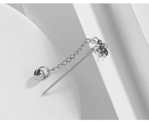 Macro shot of a silver titanium steel ear line with fine chain and spherical bead details