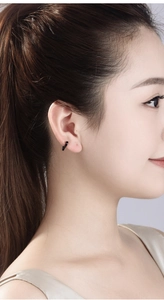 Close-up of minimalist black hoop earring in a matte finish for a punk hip hop style