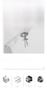 Detailed view of silver cross sword earring made of titanium steel on white stone