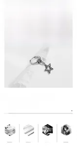 Macro view of a titanium steel earring featuring a textured hoop and beaded star pendant