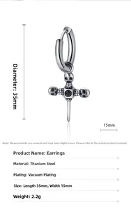 Detail of vintage silver cross earring with black stone inlay and punk skull charm
