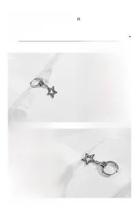 Detailed macro view of silver titanium steel star earring with vintage engraved patterns