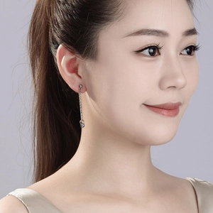 Minimalist vintage hip-hop cross steel chain earring shown on model with metallic finish
