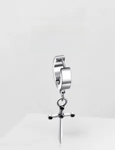 Detail of polished stainless steel earring featuring a dangling gothic sword cross charm