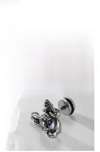 Macro shot of retro stainless steel cat stud earring with blue crystal eyes and screw back