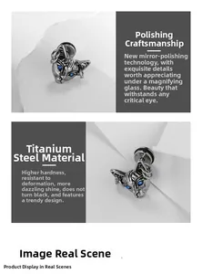 Close-up of polished titanium steel sphinx cat stud earring with blue gem eyes