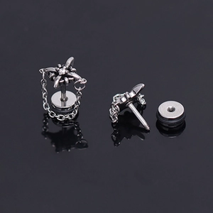 Detailed view of punk star stud earring with zircon stone and hanging silver chain link