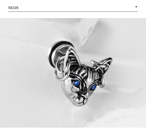Macro view of vintage silver sphinx cat stud earring with blue rhinestone eyes