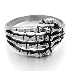 Detailed view of punk skeleton hand ring in vintage silver finish and gothic metal texture