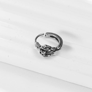 Retro gothic cross hoop earring with skeleton hand clutching a clear gemstone