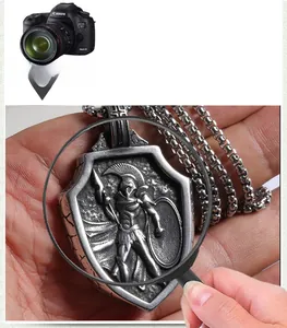 Close-up of vintage stainless steel Spartan warrior shield pendant and pearl chain detail