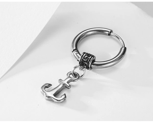 Close-up of retro anchor charm earring with engraved bead in vintage silver steel